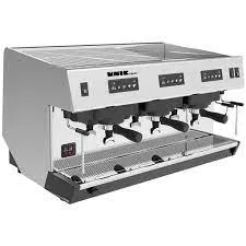 A coffee machine with three cups and four valves.
